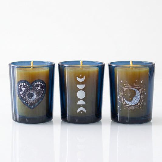 Trio of dark blue glass celestial tealight holders featuring silver moon phases and a mystical heart emblem on a white background.