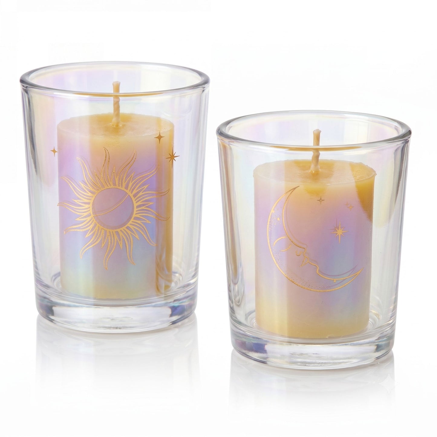 Two candles in glass holders with celestial designs on a white background