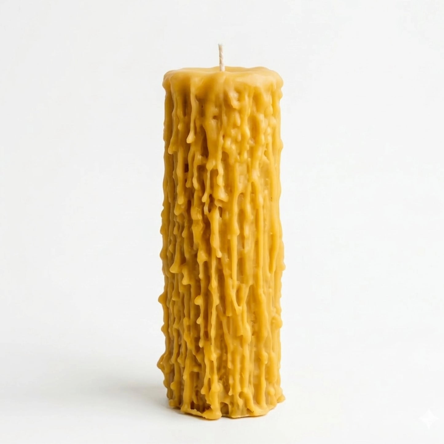 An overhead perspective of a handmade beeswax candle showing the natural cotton wick and the thick, organic pooling of wax at the top, emphasizing its non-toxic and paraffin-free composition.