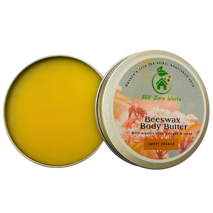 Open tin of beeswax body butter showing smooth yellow balm, rustic wooden background with avocado and nuts.