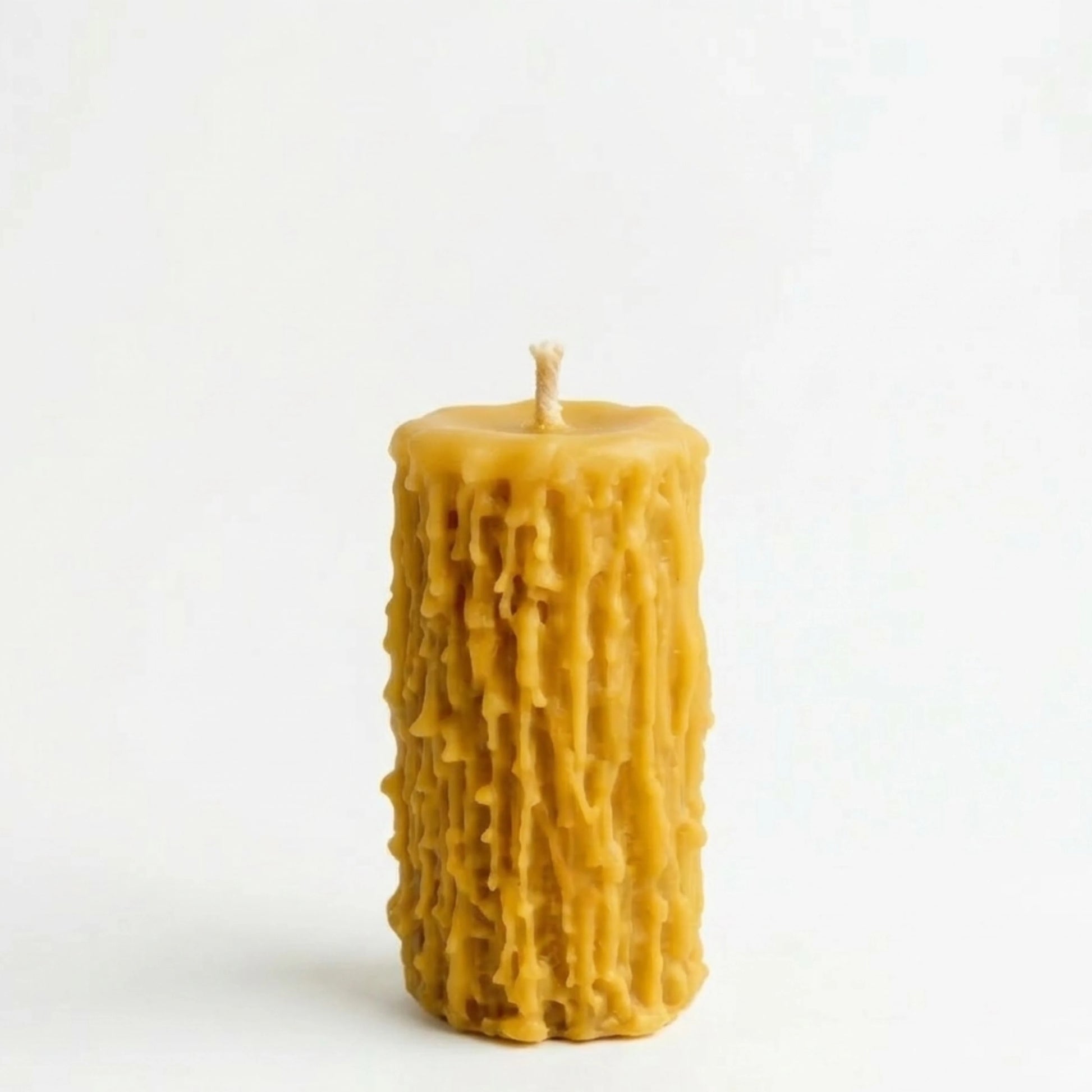 Textured beeswax candle on a white background