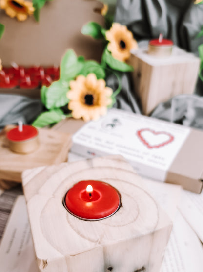 Close-up of natural red beeswax tealights burning